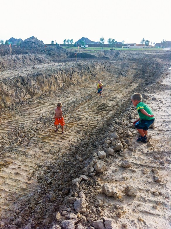 With friends, exploring the new sections of lake being dug in our neighborhood.